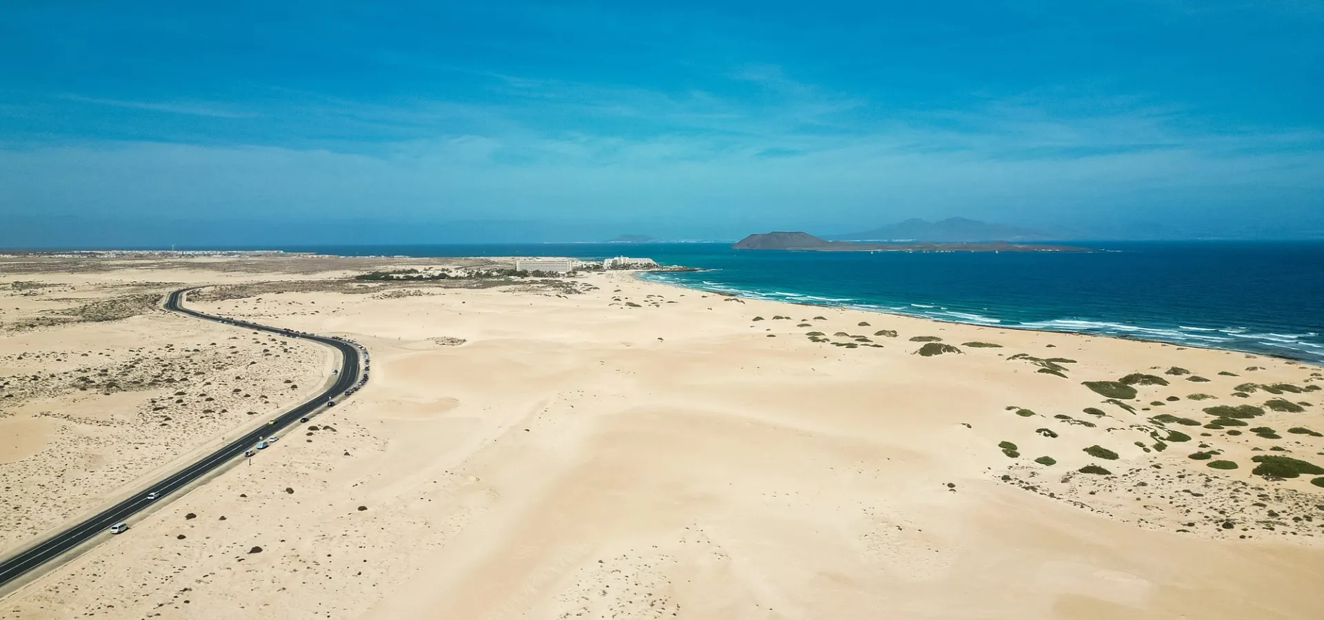 Blick über die Dünen von Corralejo auf Fuerteventura mit Lobos und Lanzarote im Hintergrund